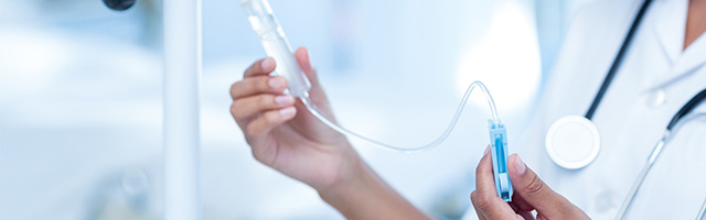 doctor preparing IV for infusion therapy services