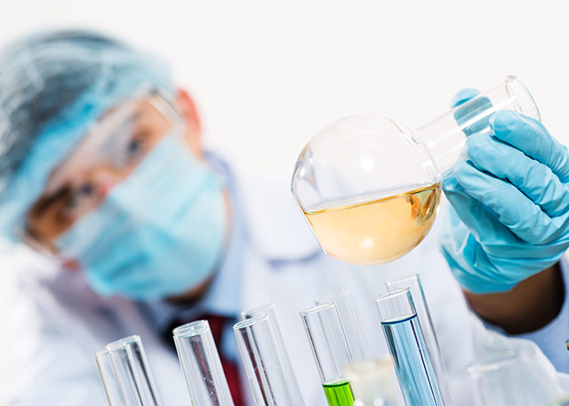 lab technician with flask and test tubes depicting our services for laboratory services